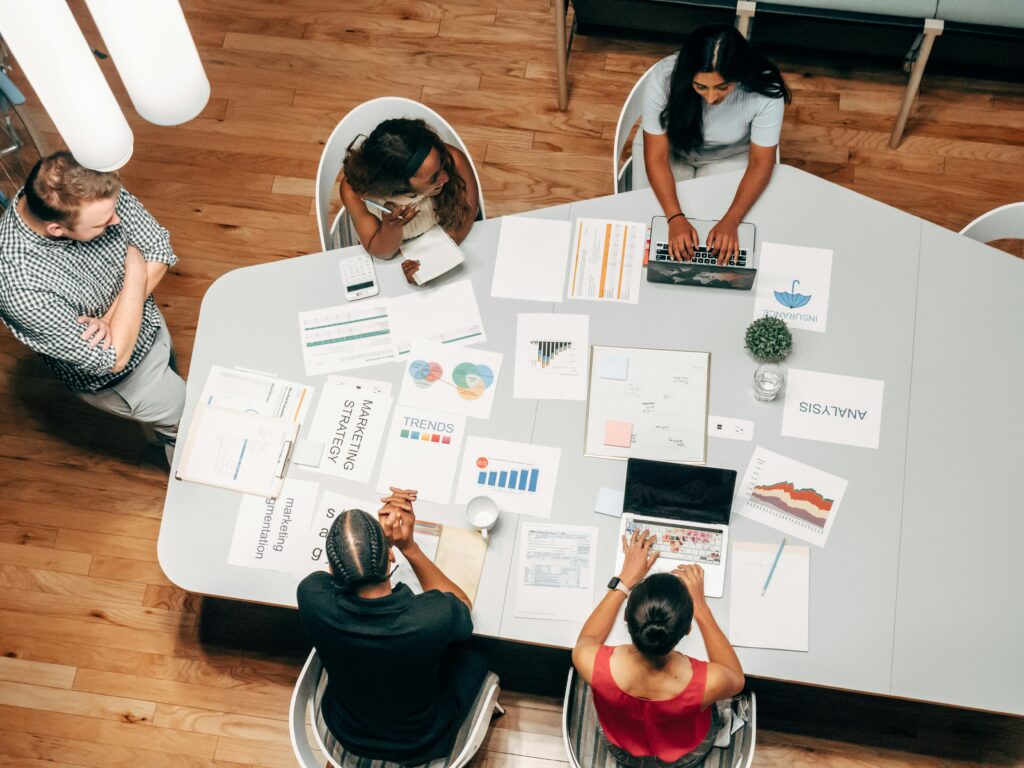 A business team analyzing AI-generated insight representing the intergration of AI tools in strategic marketing planning